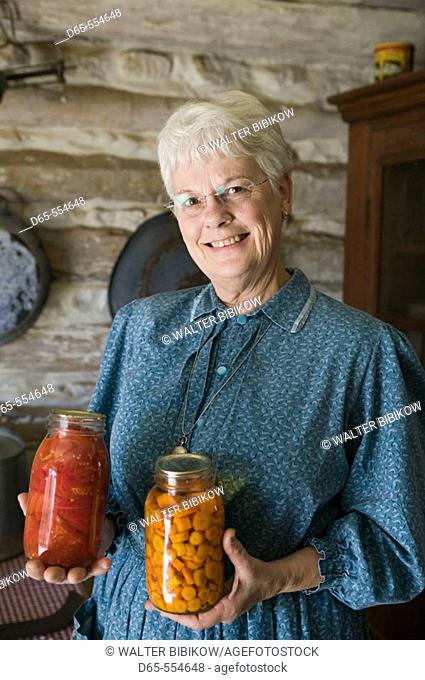 Woman with Canned Vegetables. Living History Farm at the LBJ Ranch. Johnson City. Hill Country. Texas, USA