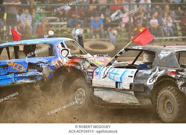 Two cars smash into each other at a demolition derby spectator event in rural Alberta Canada