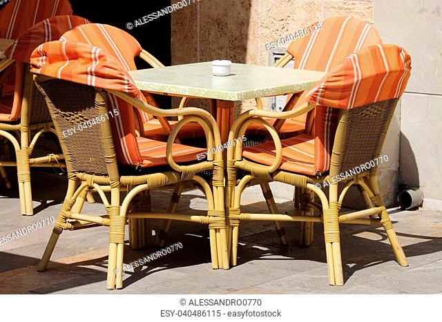 Wicker chairs and table in a street cafe