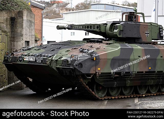 27 January 2023, Hesse, Kassel: A locally produced ""Puma"" infantry fighting vehicle stands at the entrance to the Krauss-Maffei Wegmann defense company