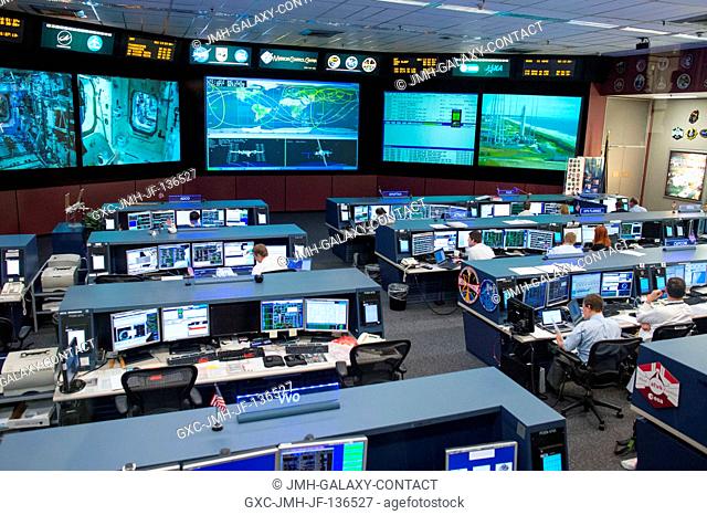In the Johnson Space Center's Mission Control Center station flight control room known as FCR-1, flight controllers support the current Expedition 37 mission...