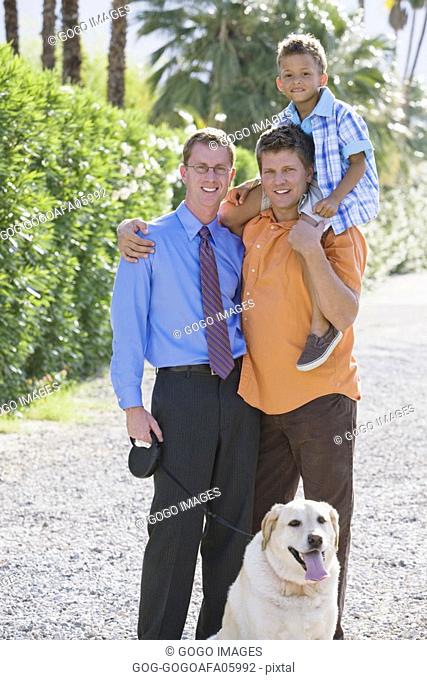 Gay couple smiling with their son