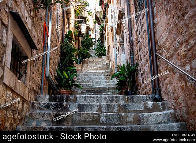 Narrow medieval alley with stairs upin Dubrovnik in winter, Croatia