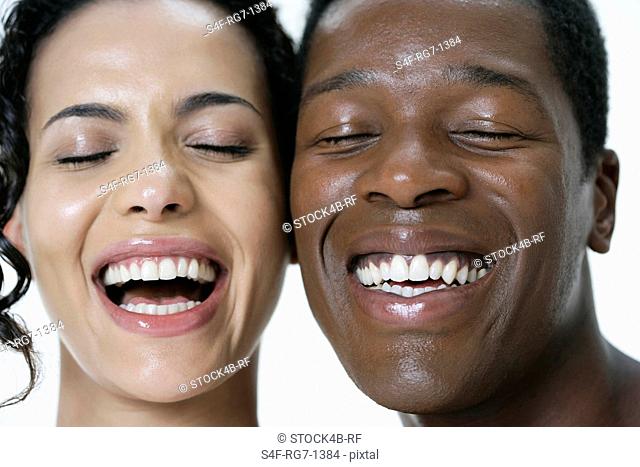 Laughing couple with eyes closed
