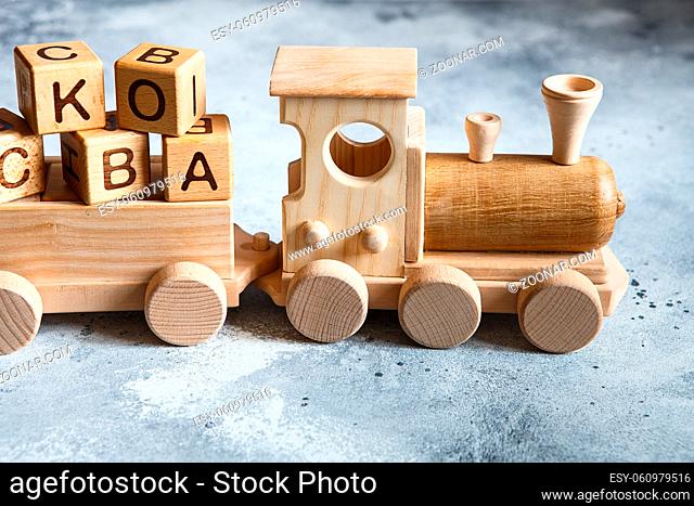 Children's wooden toys. Children wooden train with wagons. Natural wood construction set. Educational equipment