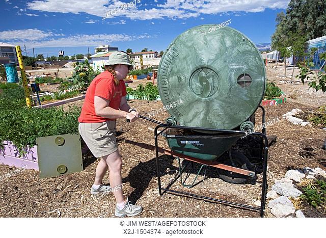 Las Vegas, Nevada - Heather Ferguson, a volunteer at Tonopah Community Garden, turns a composting bin  The nonprofit garden grows organic produce which is...