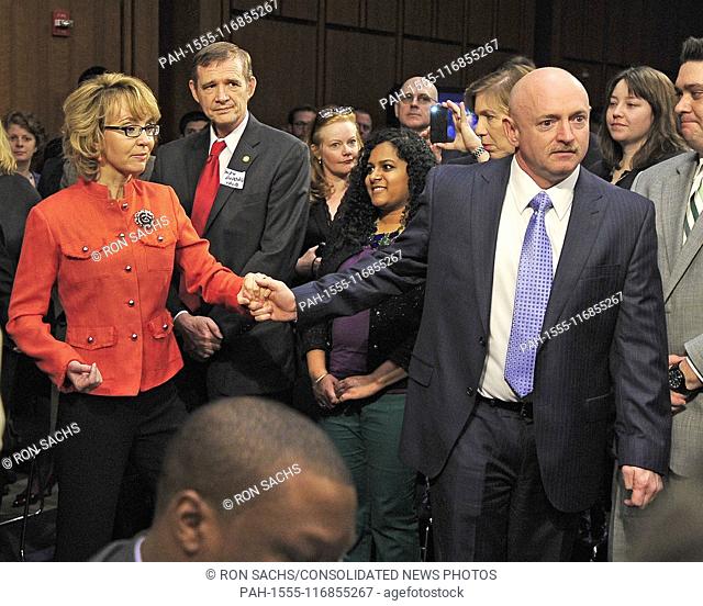 Captain Mark Kelly, United States Navy (Retired), representing Americans for Responsible Solutions, right, leads his wife, former U.S