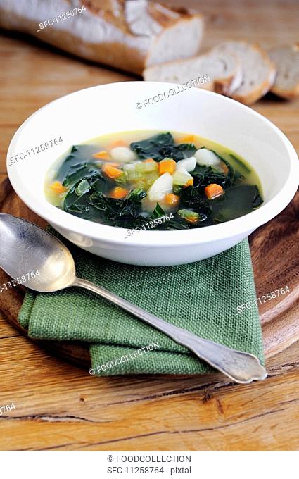 Minestrone soup with black kale, onions, potatoes, carrots and celery