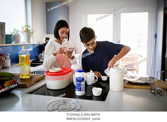 Mixed Race brother and sister baking in kitchen