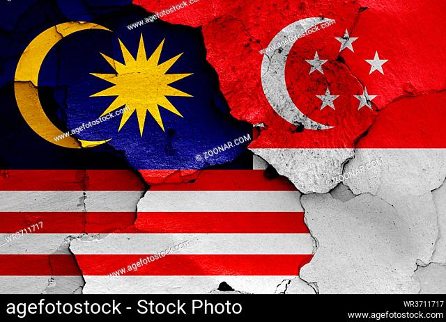 flags of Malaysia and Singapore painted on cracked wall