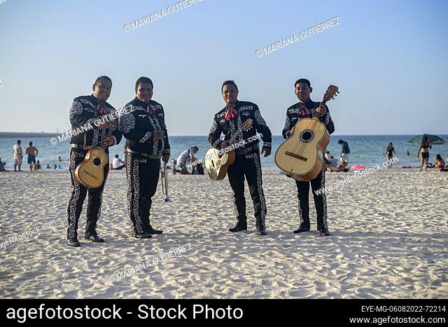 August 6, 2022, Progreso, Mexico: Mariachis offer songs to tourists who visit the beaches of Puerto Progreso in the Yucatan Peninsula during the holiday summer...