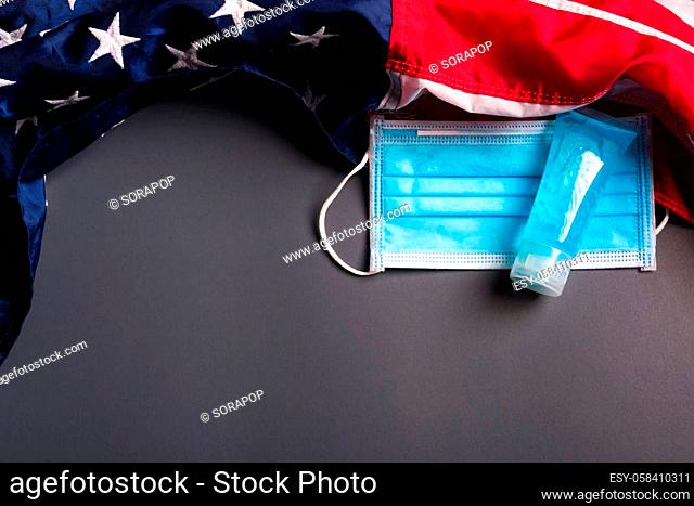 Medical protective disposable face mask for cover mouth and America flag, studio shot on gray background, Safety healthcare medical prevent coronavirus or...