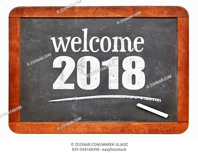 Welcome 2018 - New Year concept on a vintage slate blackboard isolated on white