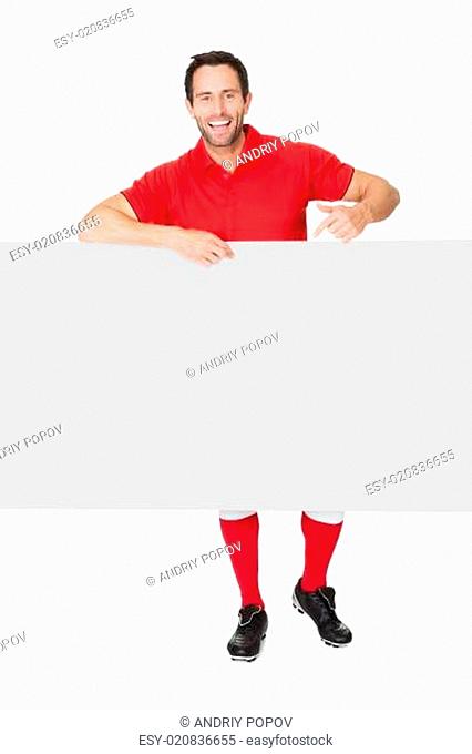 Portrait of soccer player presenting empty banner