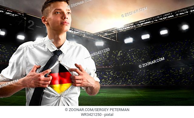Germany soccer or football supporter showing flag under his business shirt on stadium