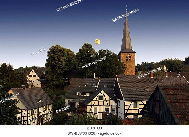 view to old town and steeple, moon in background, Germany, North Rhine-Westphalia, Wetter-Volmarstein