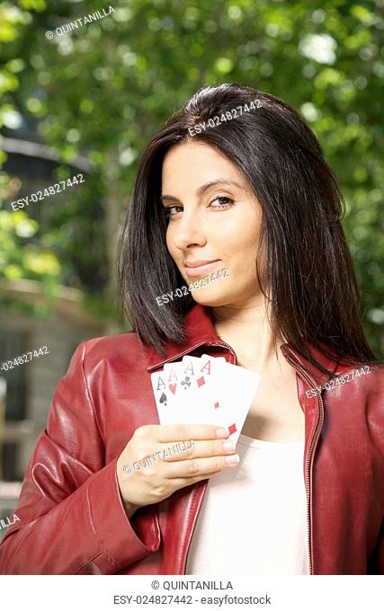 pretty woman with four aces in her hand