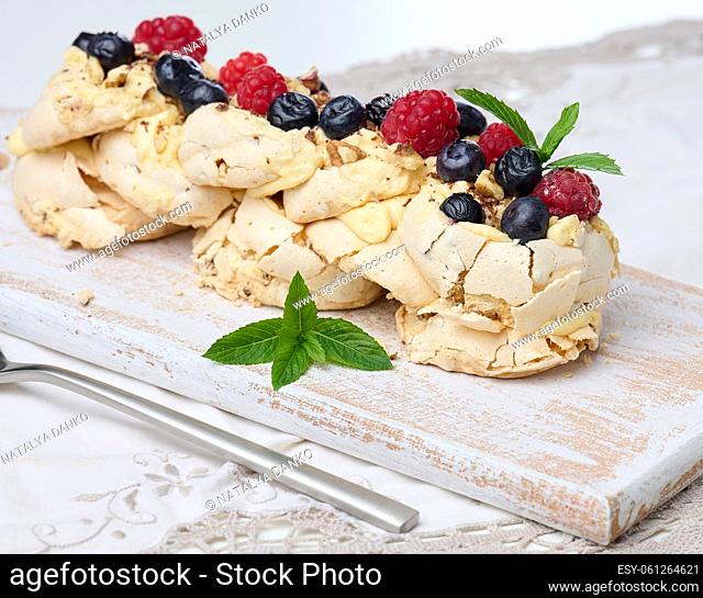 Baked cake made from whipped chicken protein and cream, decorated with fresh berries. Dessert Pavlova
