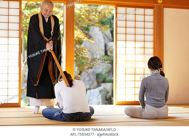 Japanese priest preaching to women at a temple