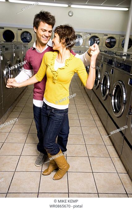Couple dancing in Laundromat