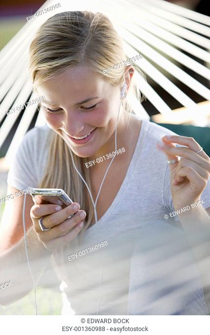 Girl listening to MP3 player and snapping fingers