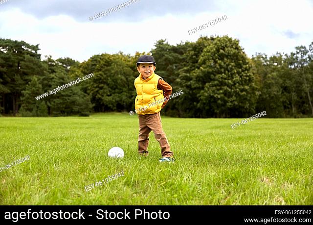 little boy with soccer ball at park