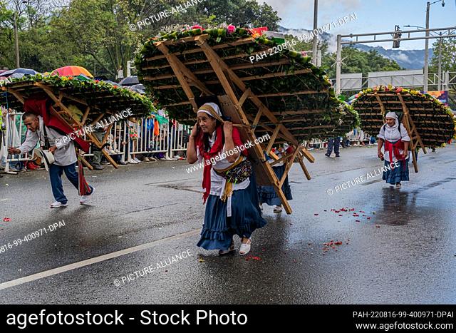 15 August 2022, Colombia, Santa Elena Antioquia: Various silleteros dressed in typical costumes participate in a parade as part of the Medellin Flower Festival