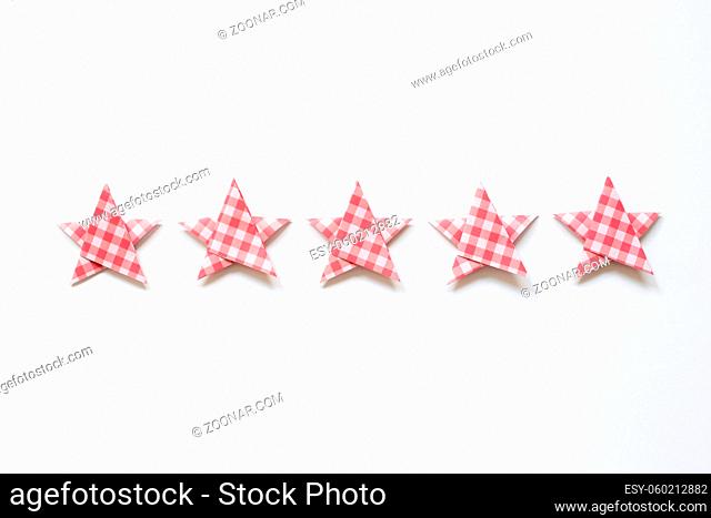 Red check pattern five stars quality rating on white background. top view