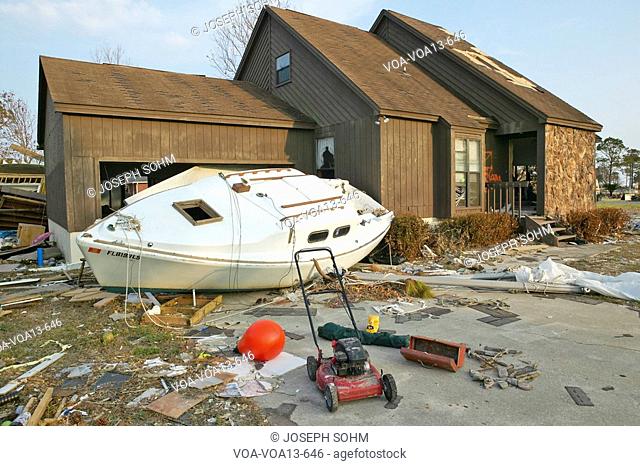 Boat and debris in front of house heavily hit by Hurricane Ivan in Pensacola Florida