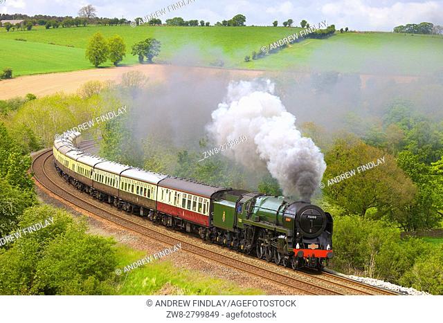 Steam train Britannia on the embankment at Low Baron Wood Farm, Armathwaite, Settle to Carlisle Railway Line, Eden Valley, Cumbria, England, UK