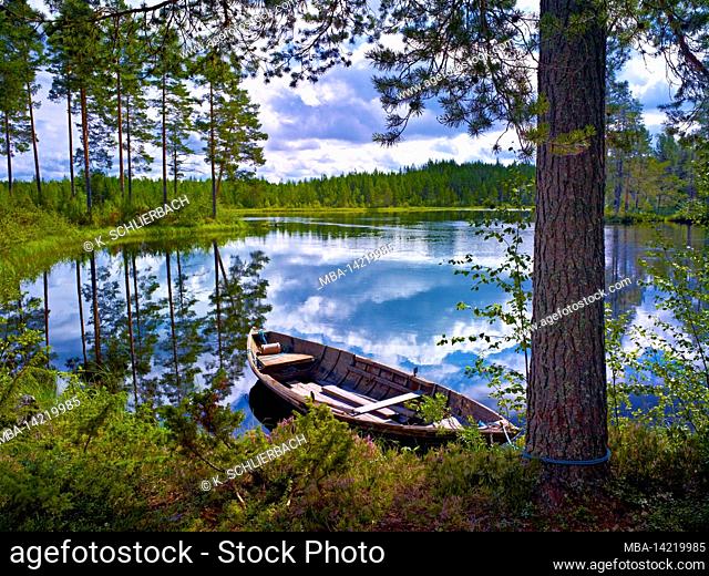 Europe, Sweden, Värmland province, lake with wooden boat at Filipstad