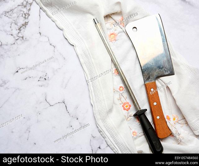 knife and old iron sharpener with handle for kitchen knives on a white background, top view, copy space