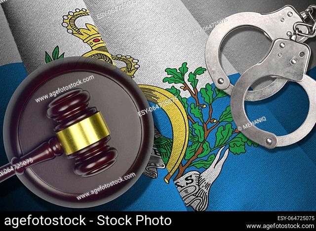 San Marino flag with judge mallet and handcuffs in dark room. Concept of criminal and punishment, background for guilty topics