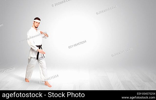 Young kung-fu trainer fighting in an empty space