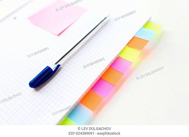 business, information, memo, management and education concept - close up of notebook or organizer with blank tags and pen on office table