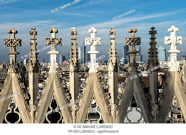Italy, Lombardy, Milan, Duomo spires with cityscape