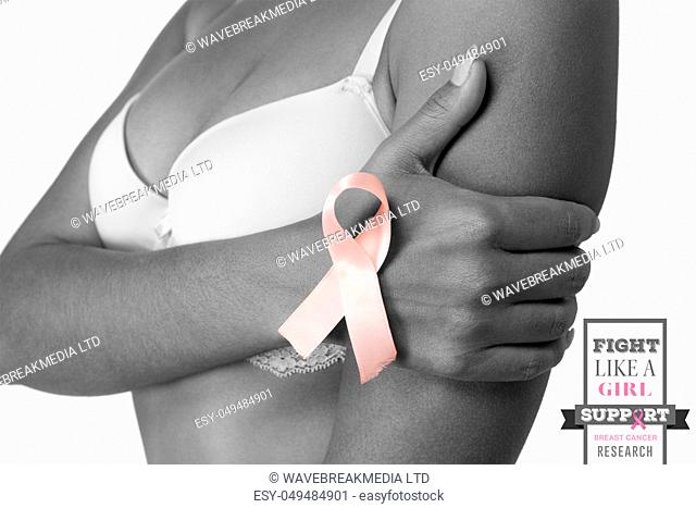 Breast cancer awareness message against woman for breast cancer awareness in bra with ribbon