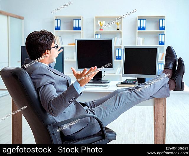 The businessman sitting in front of many screens