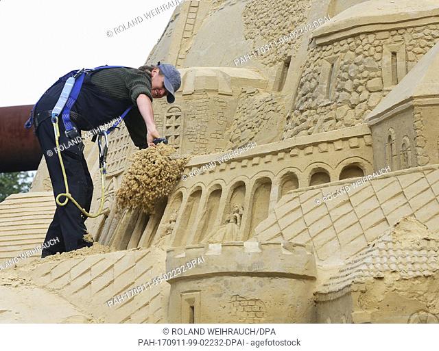 The tallest sand castle in the world is being repaired with the help of a cherry picker at the Landschaftspark in Duisburg, Germany, 11 September 2017