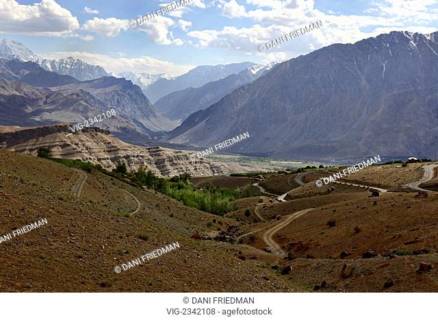 INDIA, KARGIL, 10.07.2010, A scenic mountain view of the Kashmir-Ladakh Himalayan Mountain Range towers over a winding mountain road