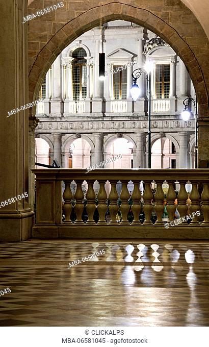 Arc of St. Alexander Cathedral entrance with his marble floor wich reflect lights and ancient parapet, Bergamo Alta, Lombardy, Italy