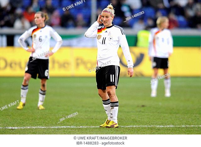 Anja Mittag, Simone Laudher rear left, at women's international footballmatch Germany-North Korea 3-0 in the MSV Arena in Duisburg, North Rhine-Westphalia