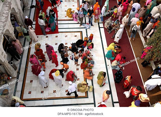Devotees at Harmandir Sahib or Darbar Sahib or Golden temple in Amritsar ; Punjab ; India