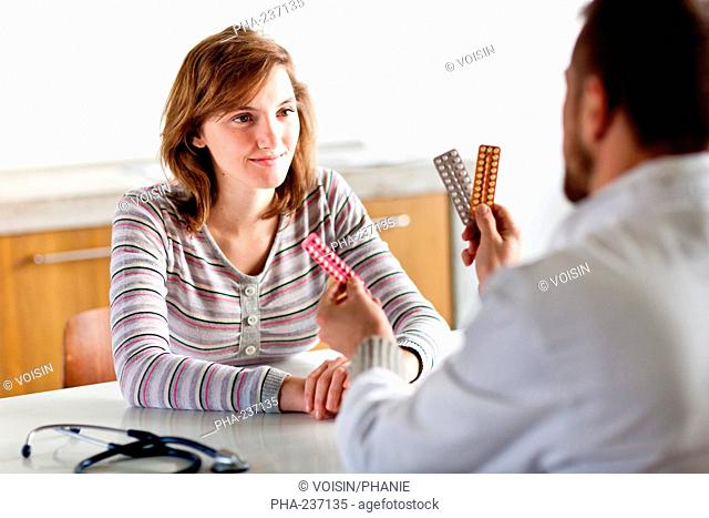 General practice doctor discussing oral contraception with a teenager