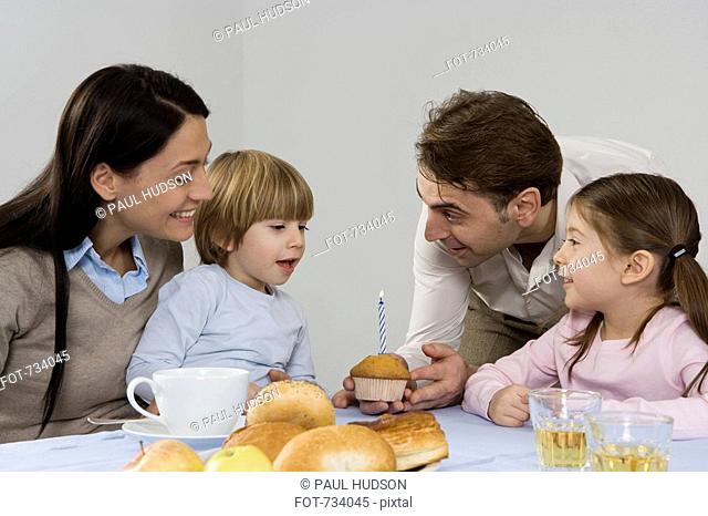 A family celebrating a the birthday of their son