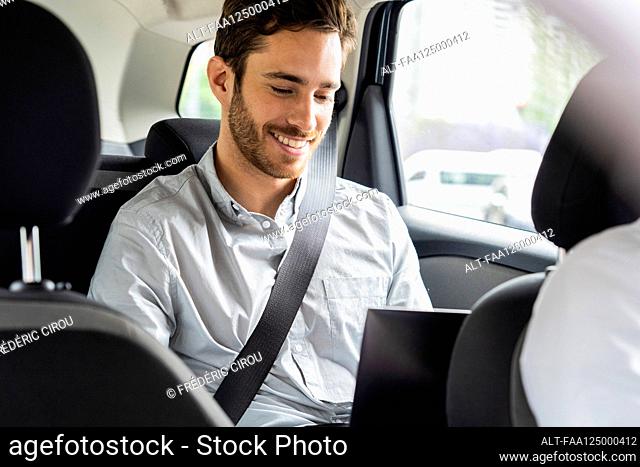 Young man travelling by taxi