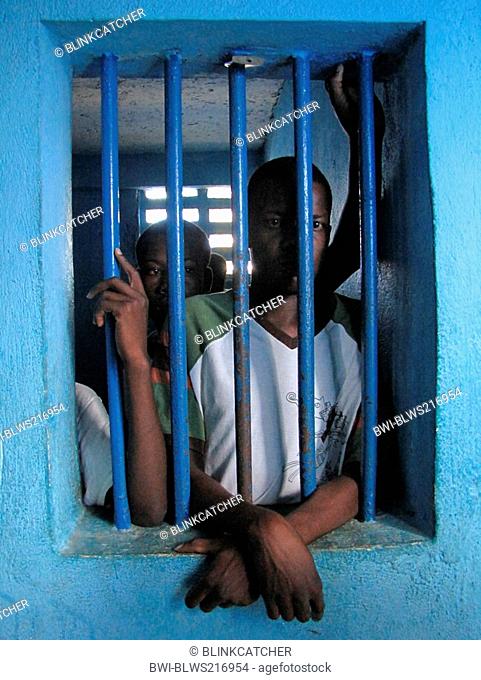 detainees behind bars of a window in run-down predetention cell garde à vue at police station, commissariat of Jérémie, Haiti, Grande Anse, Jeremie