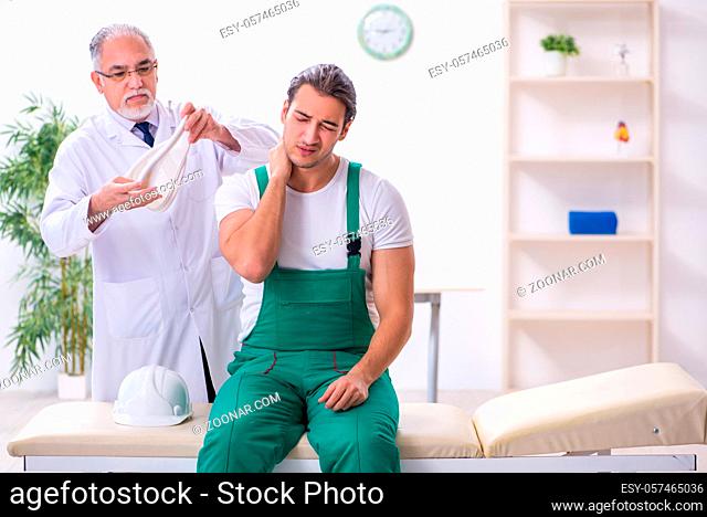 Young contractor visiting old doctor