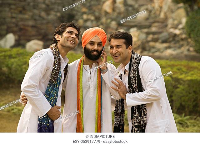Men listening to Sikh man talking