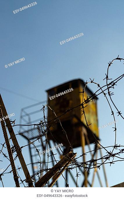 Barbed wire and watchtower of the military unit